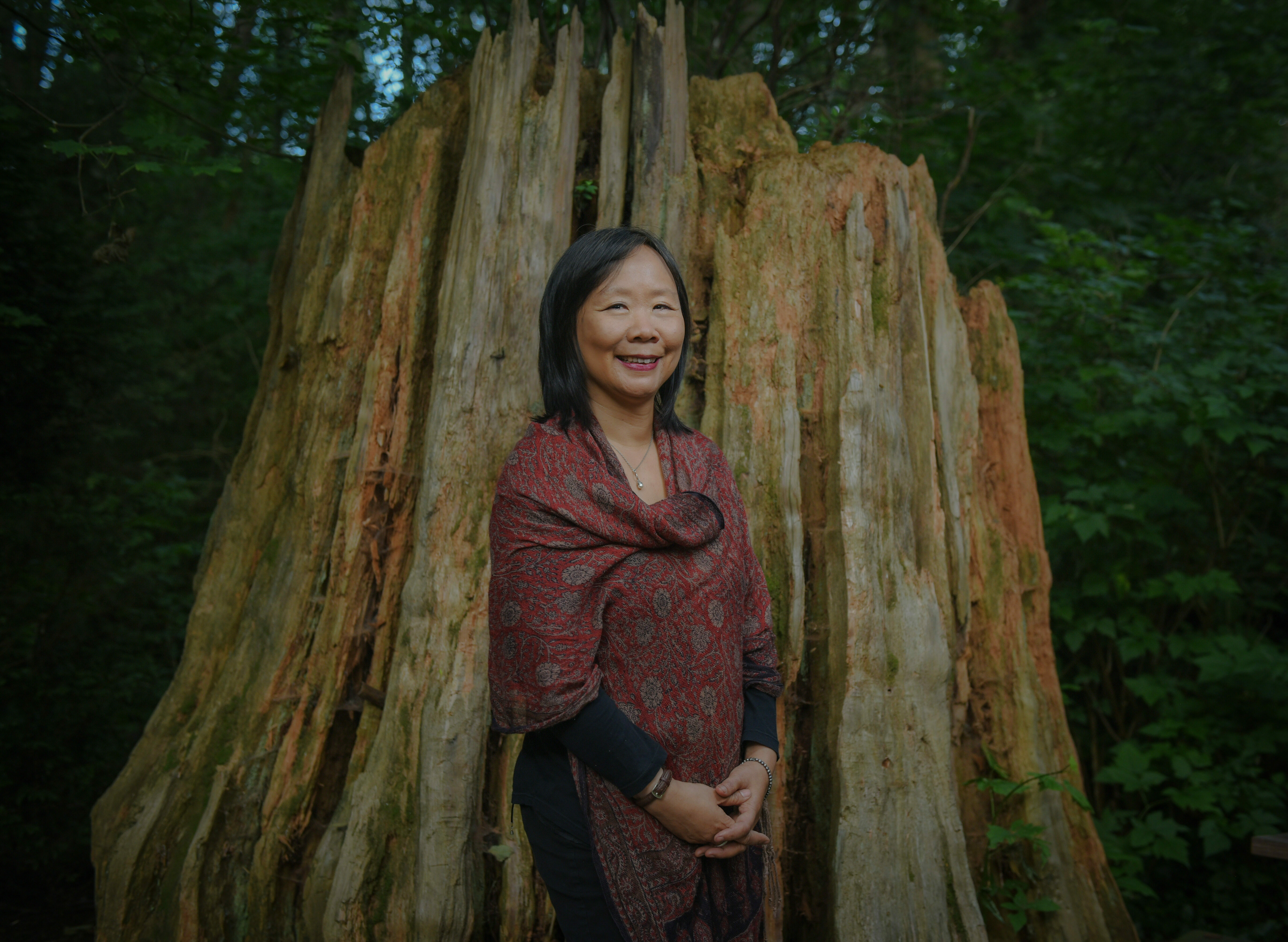 Fiona Lam stands in front of a tree stump
