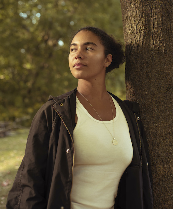 Author photo of Lue Palmer, posed beside a tree outside